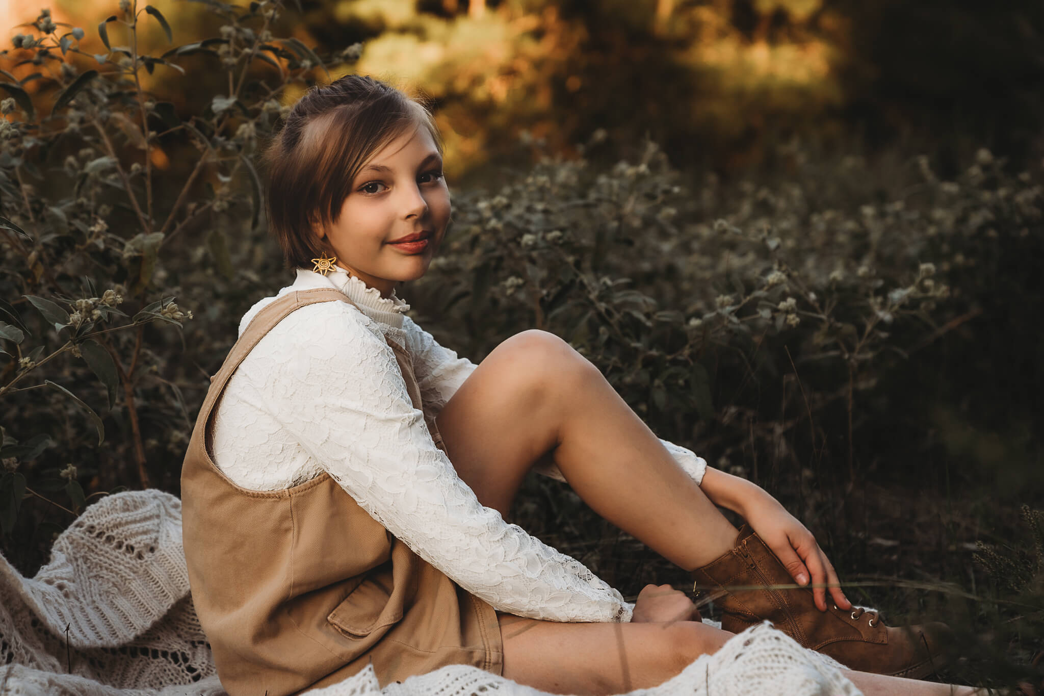 girl sitting during golden hour wearing lots of textured clothes. 