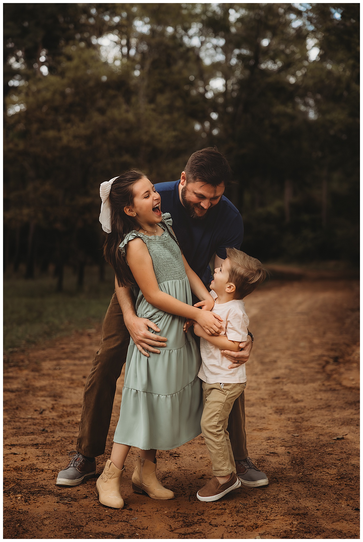 Dad holds kids close for Maria Grace Photos