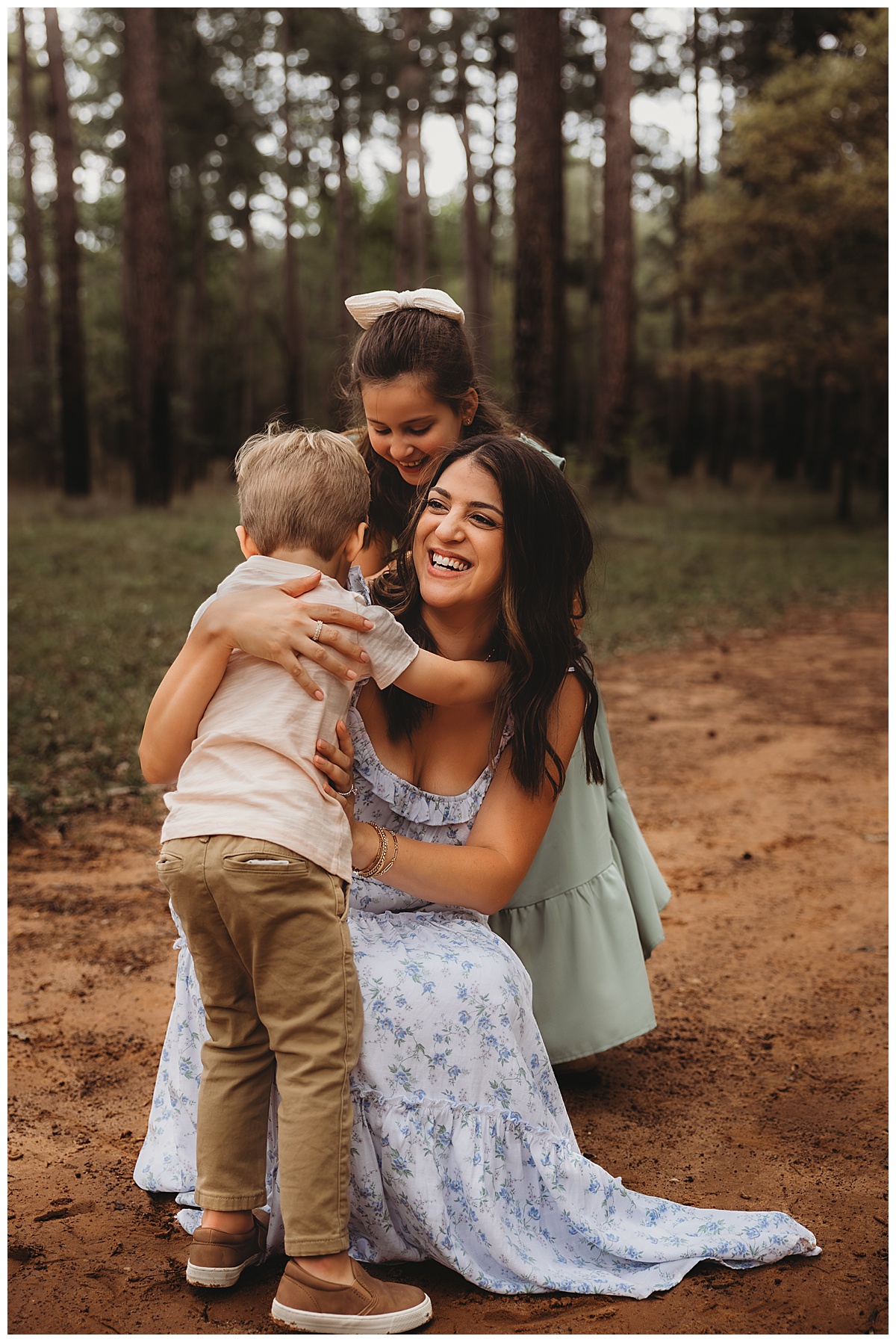 Mom smiles with kids by The Woodlands Family Photographer