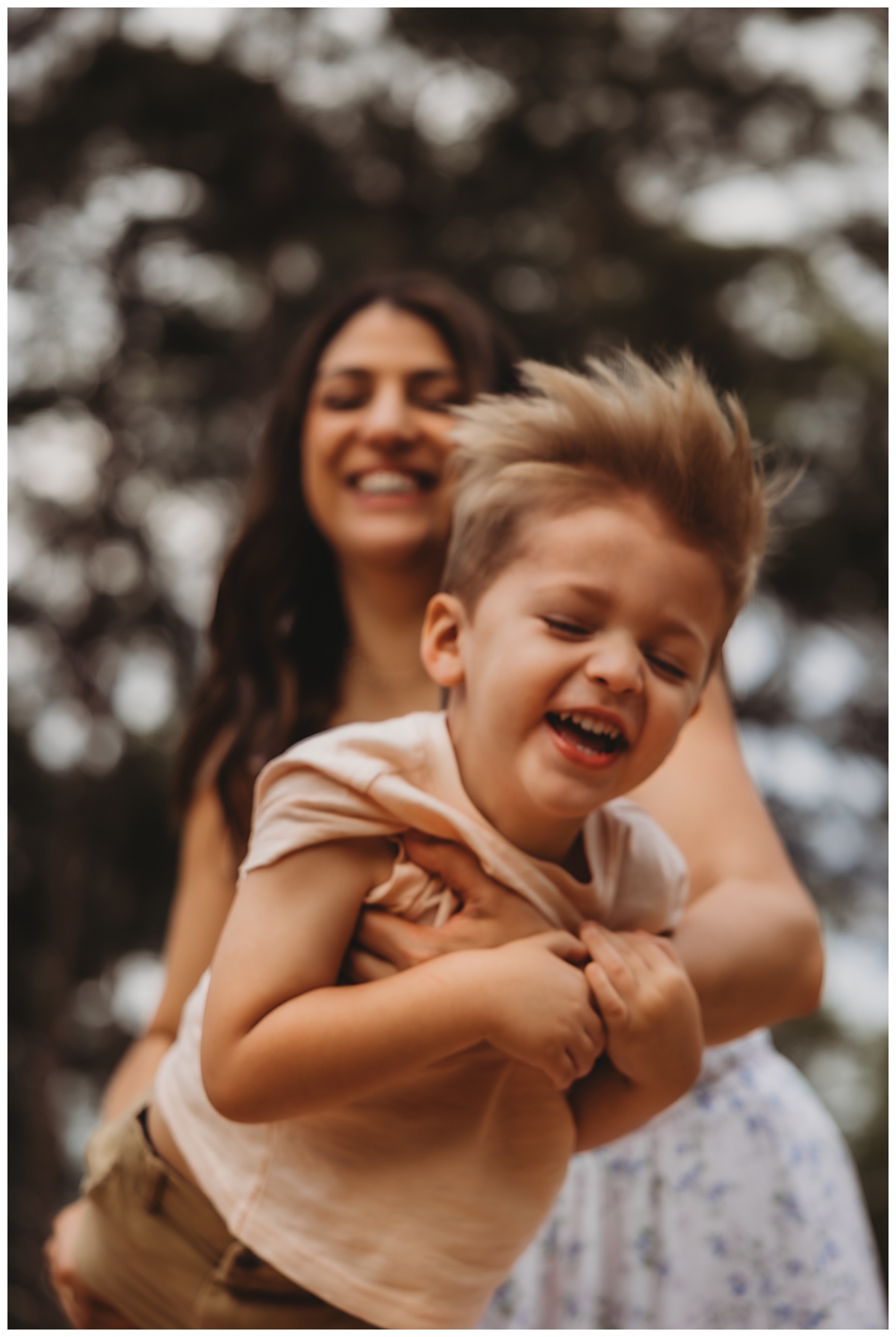 Young boy shares a big smile with his mom showing Why You Should Coordinate Outfits Instead Of Matching For Your Family Photos 