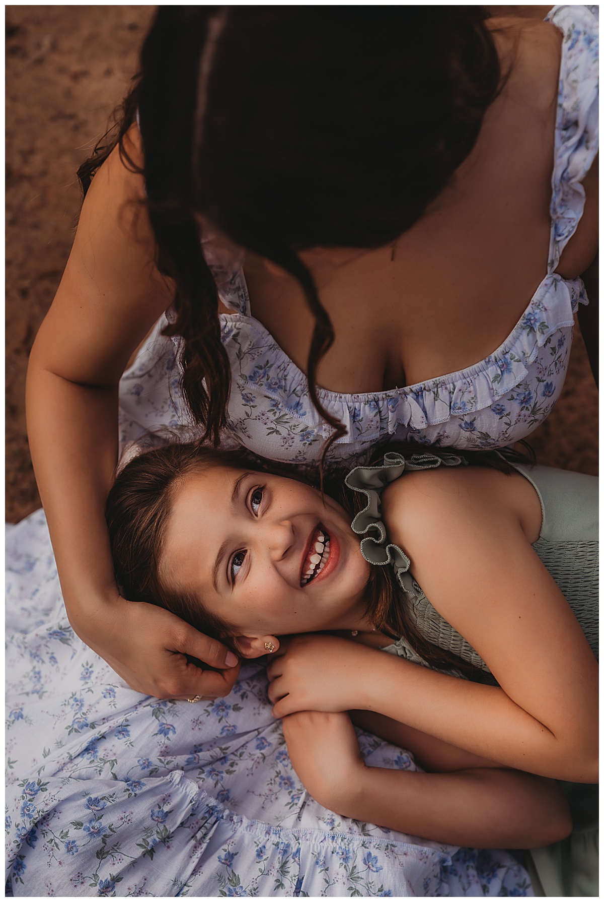 Girl smiles at mom by The Woodlands Family Photographer