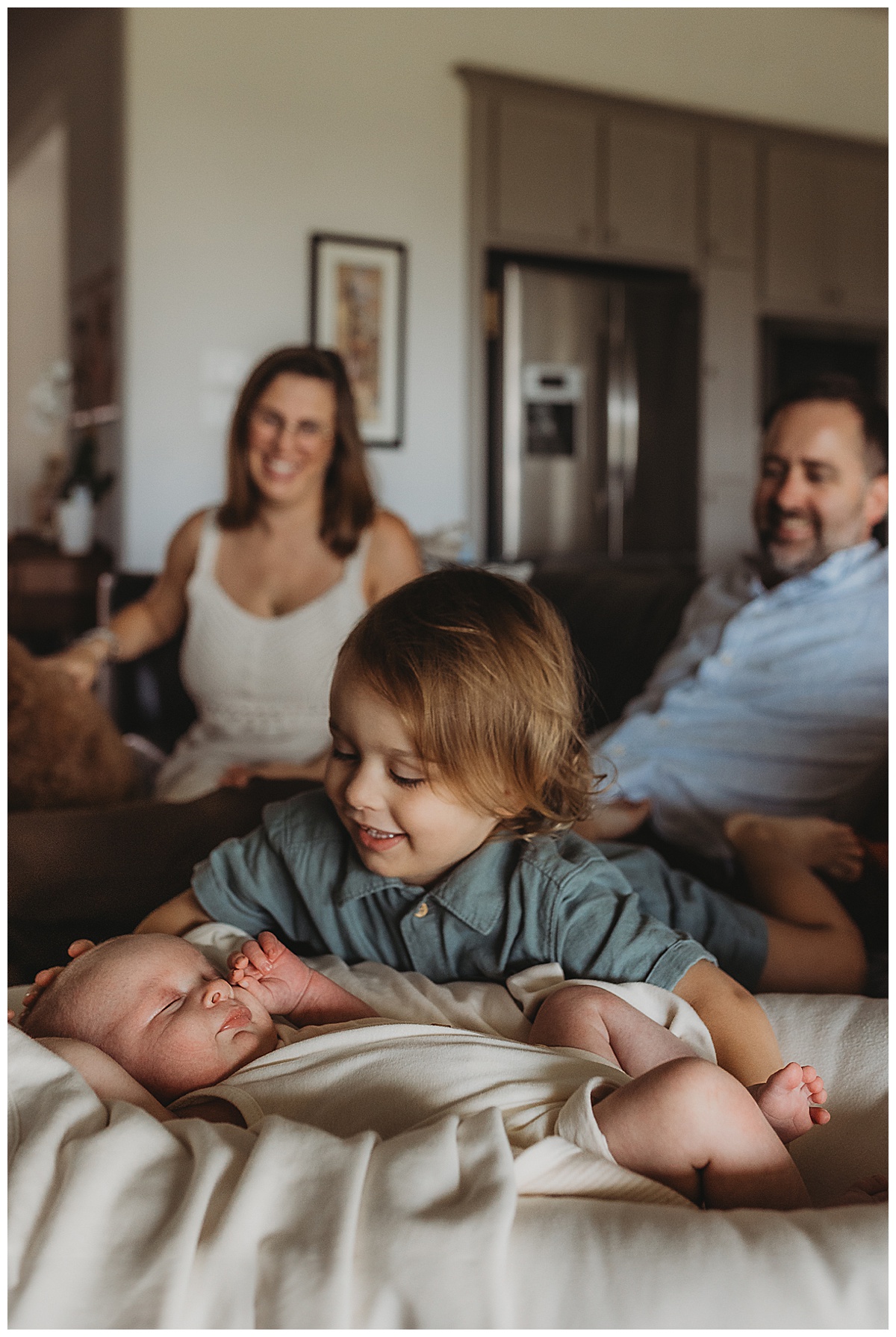 Sibling smiles at baby for The Woodlands Family Photographer