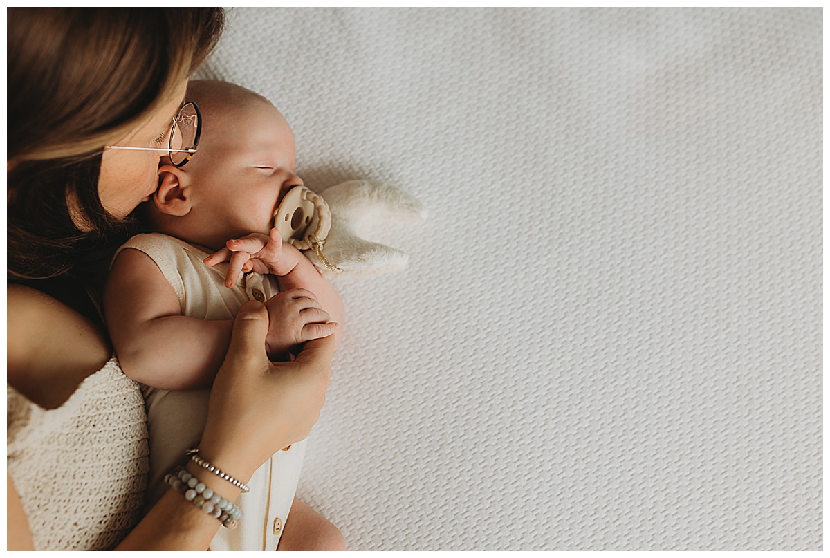 Baby lays on the blanket showing Why You Should Choose An In-Home Newborn Session 