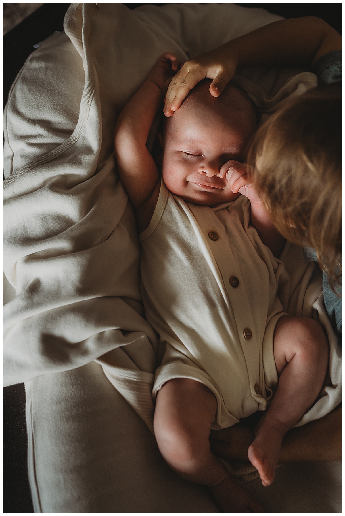 Sibling kisses young baby for The Woodlands Family Photographer