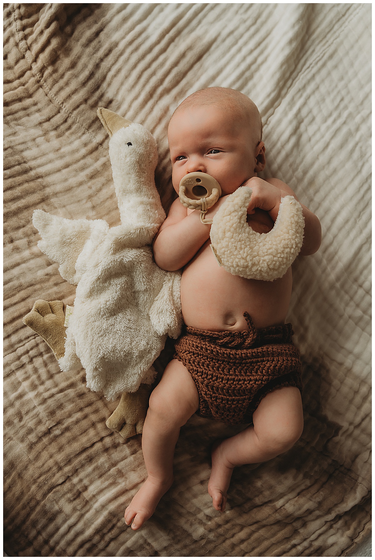 Young baby lays on the bed for Maria Grace Photos