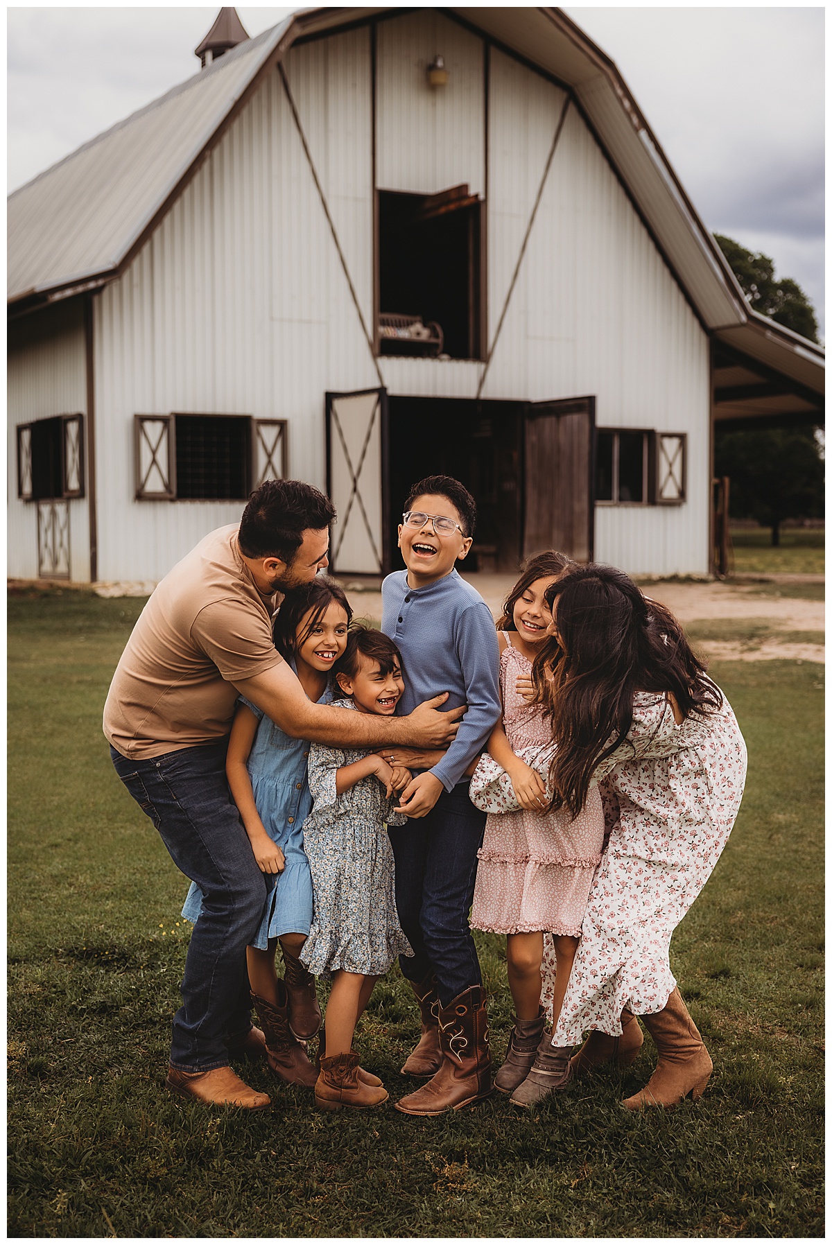 Family cuddle together and hold each other for The Woodlands Family Photographer