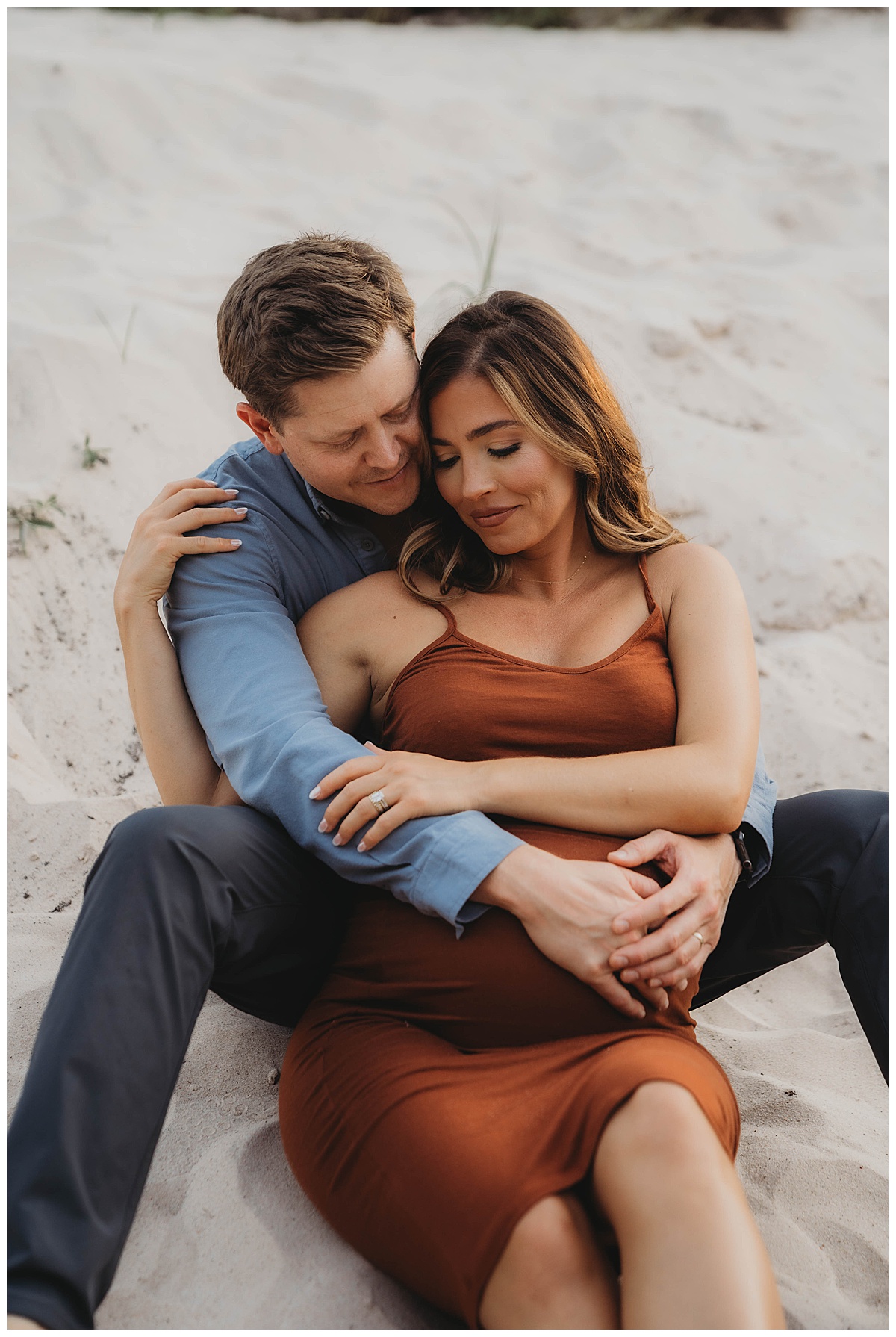 Mom and dad cuddle together embracing the baby bump showing the Perfect Time for Maternity Photos