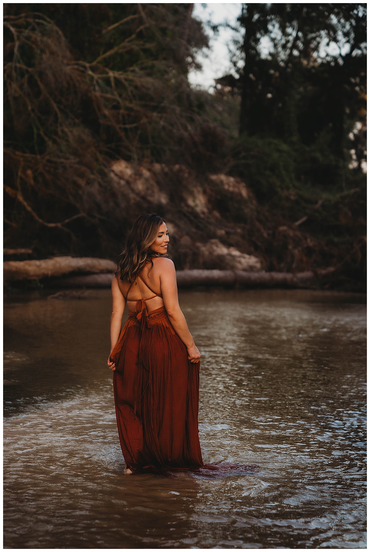 Woman walks in the water by The Woodlands Family Photographer