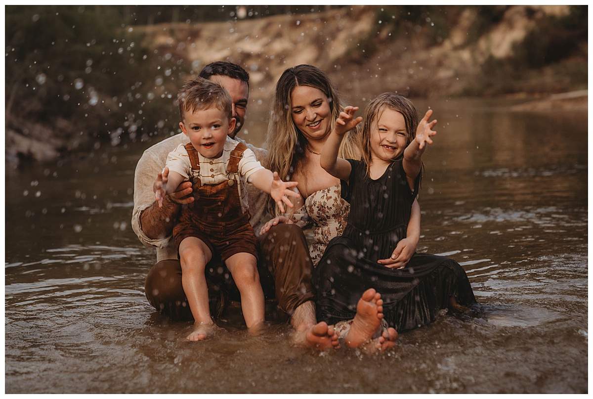 Family splash in the water by The Woodlands Family Photographer