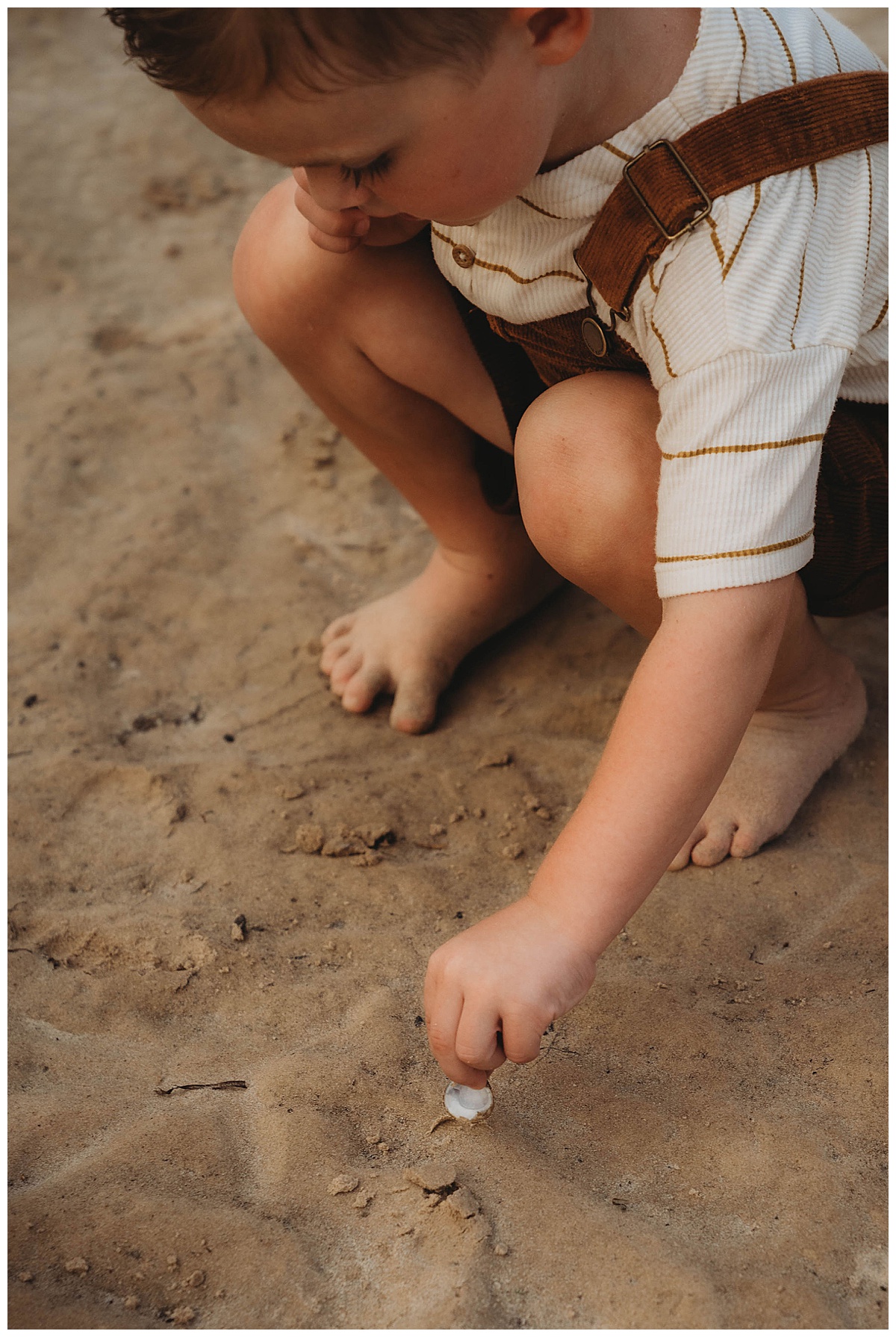 Young boy plays in the water showing a reason Why you should choose Lifestyle Photography for Your Family