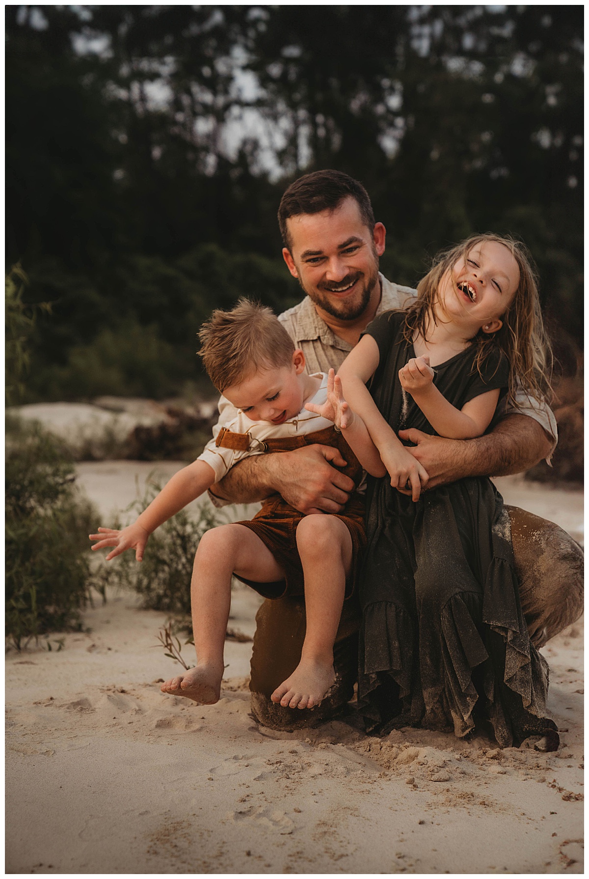 Dad holds kids close showing a reason Why you should choose Lifestyle Photography for Your Family