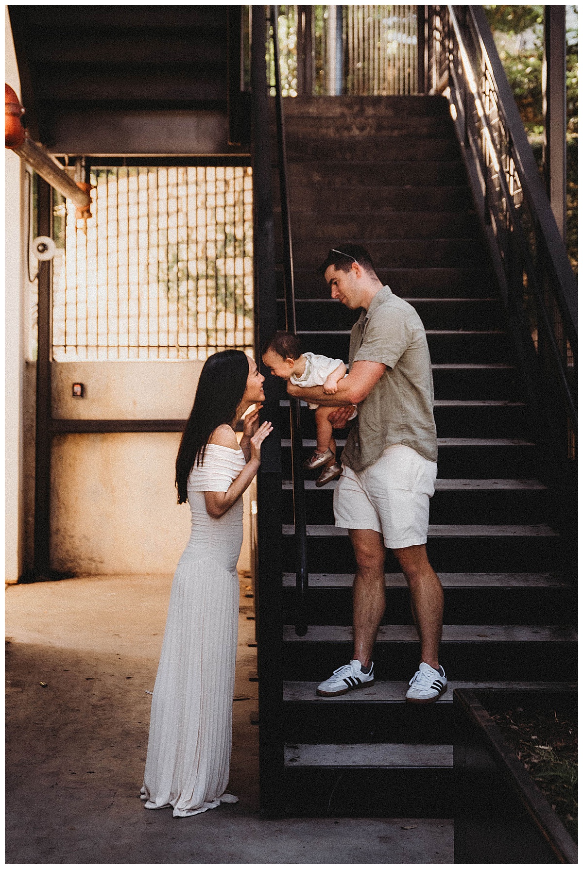 Parents kiss their baby at one of my favorite Urban Locations