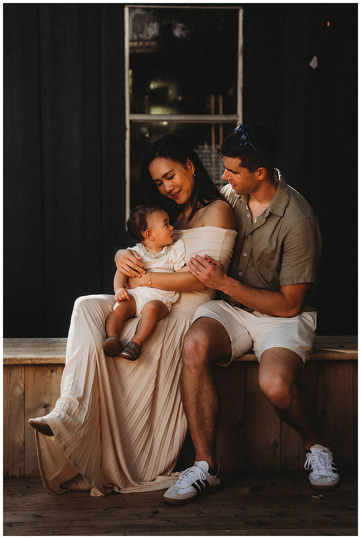 Parents sit with their baby for Maria Grace Photos