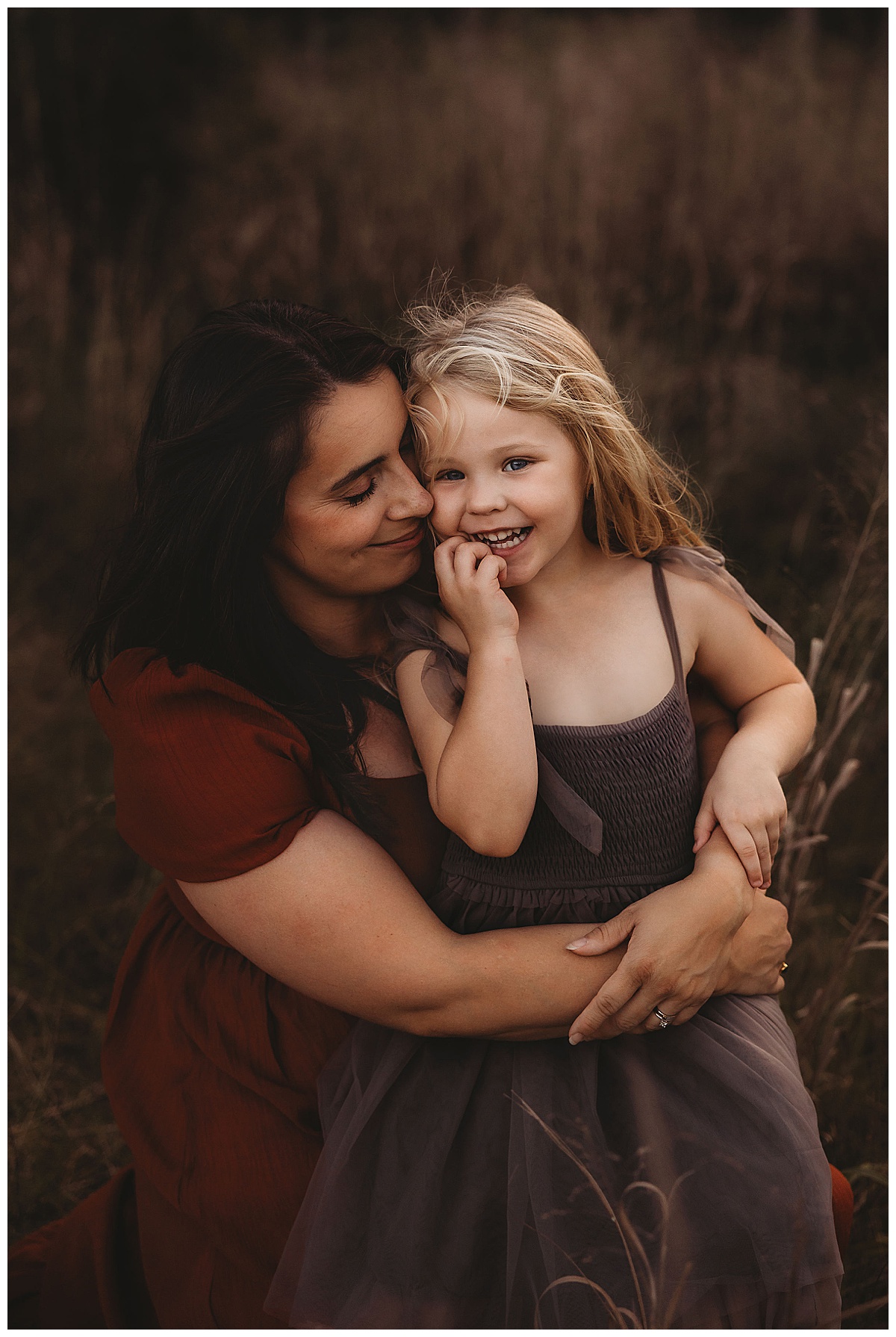 Mom cuddle young daughter for The Woodlands Family Photographer