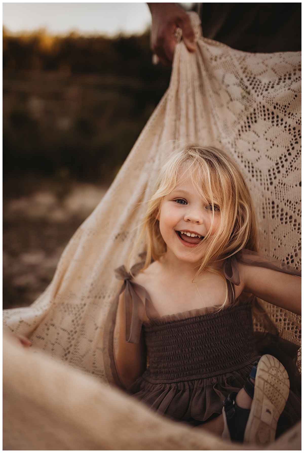 Young girl sits in the blanket for Maria Grace Photos