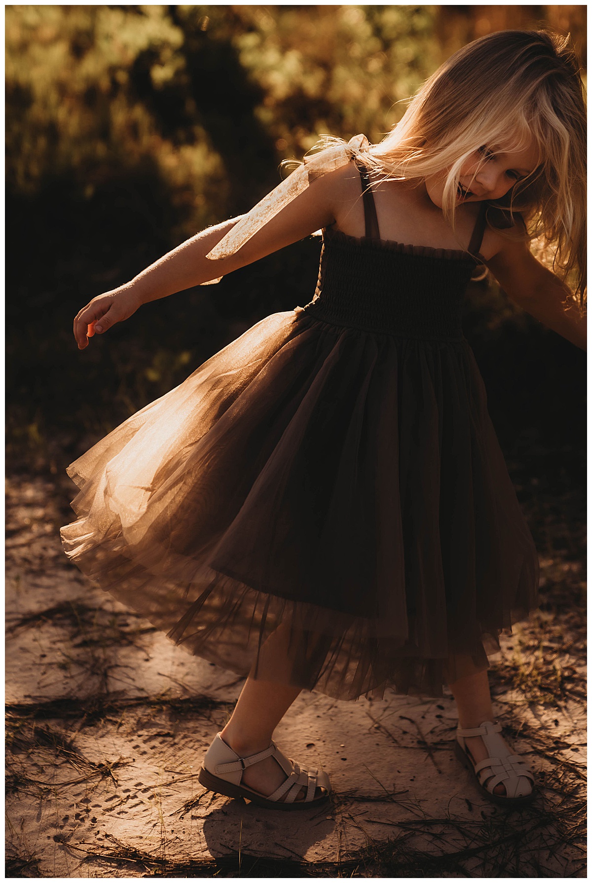 Young girl walks in the dirt following my suggestion of Golden Hour for Family Photos