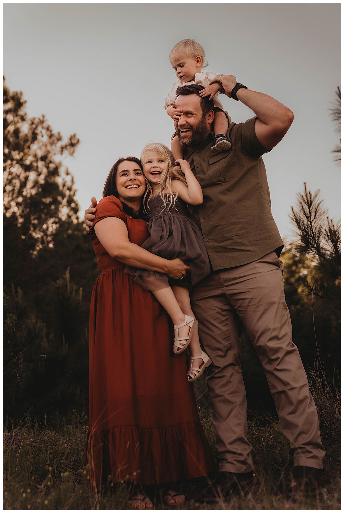 Parents hold their kids for Maria Grace Photos