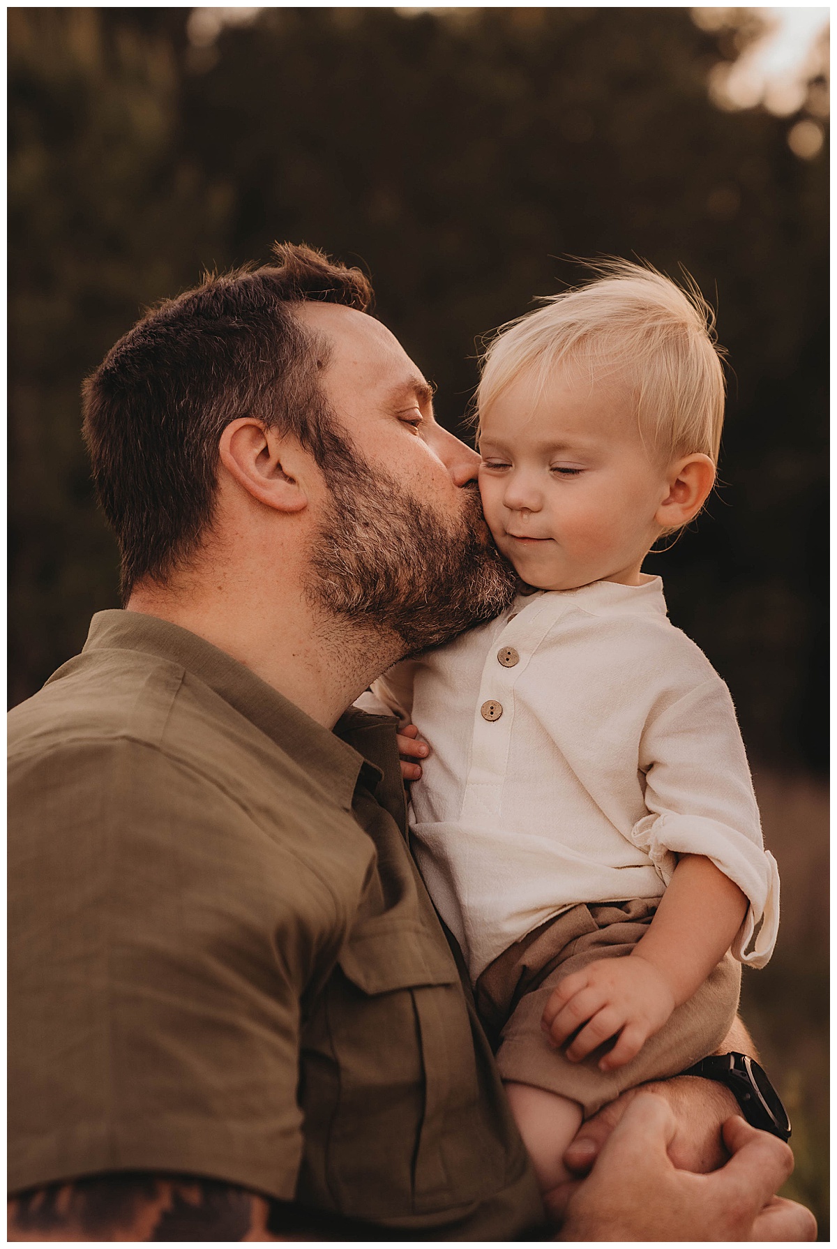 Dad kisses son on the cheek for The Woodlands Family Photographer