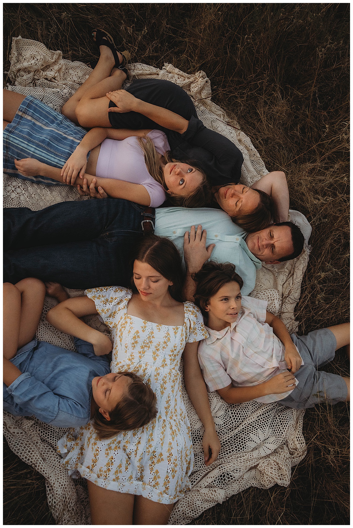 Family lay together on the blanket for The Woodlands Family Photographer