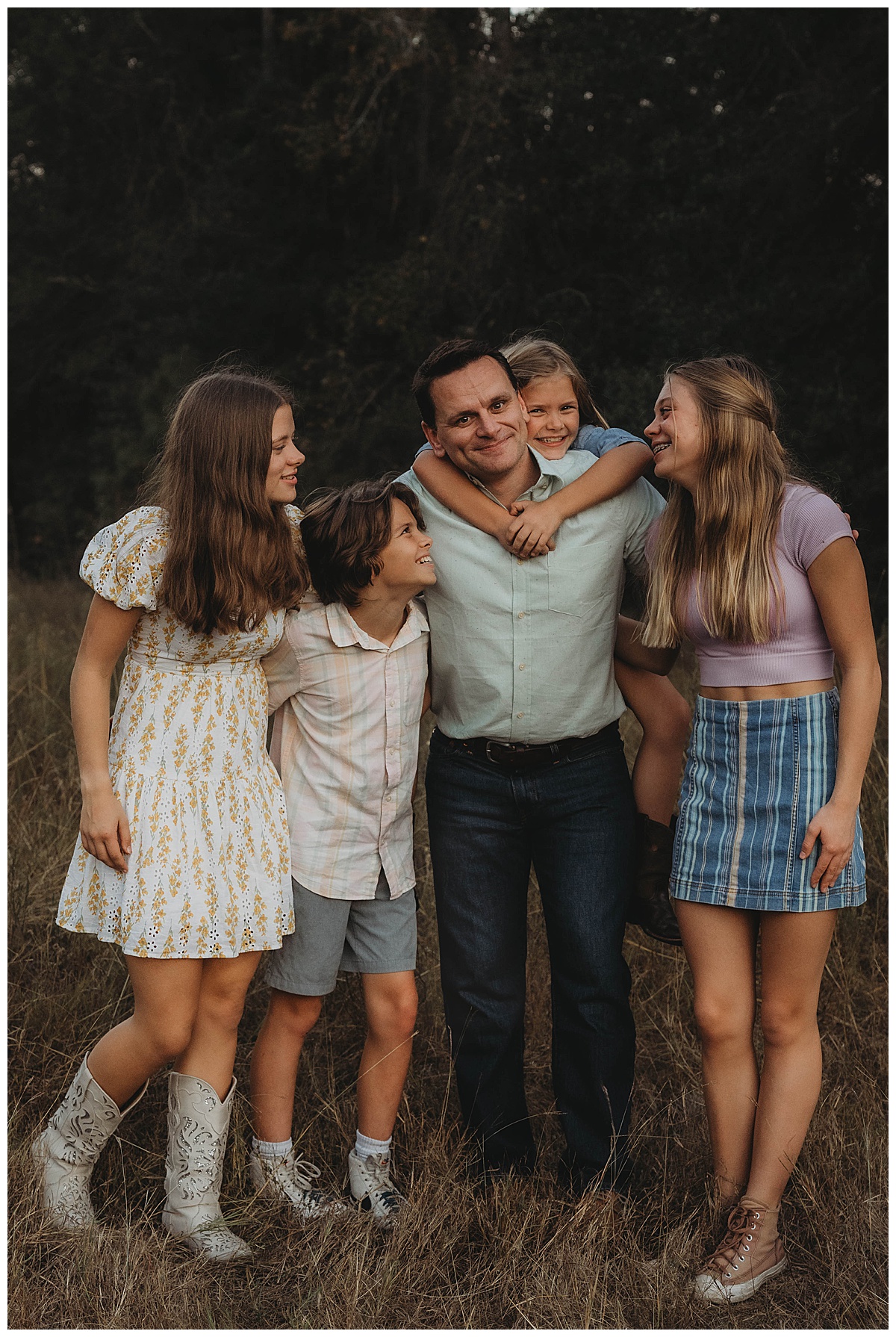 Dad stands ands miles with kids for The Woodlands Family Photographer