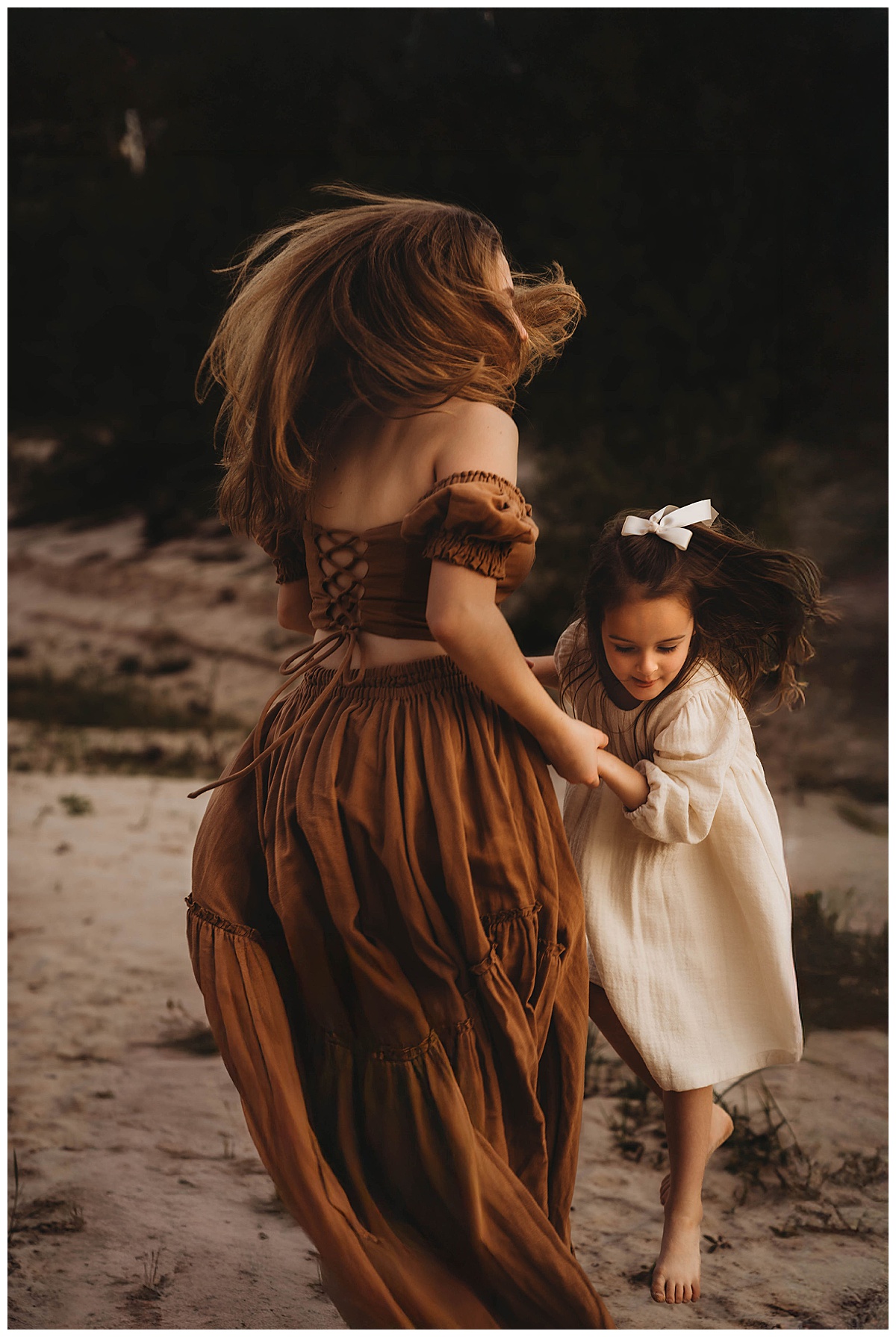 Mother and daughter dance around together wearing a dress from my client closet