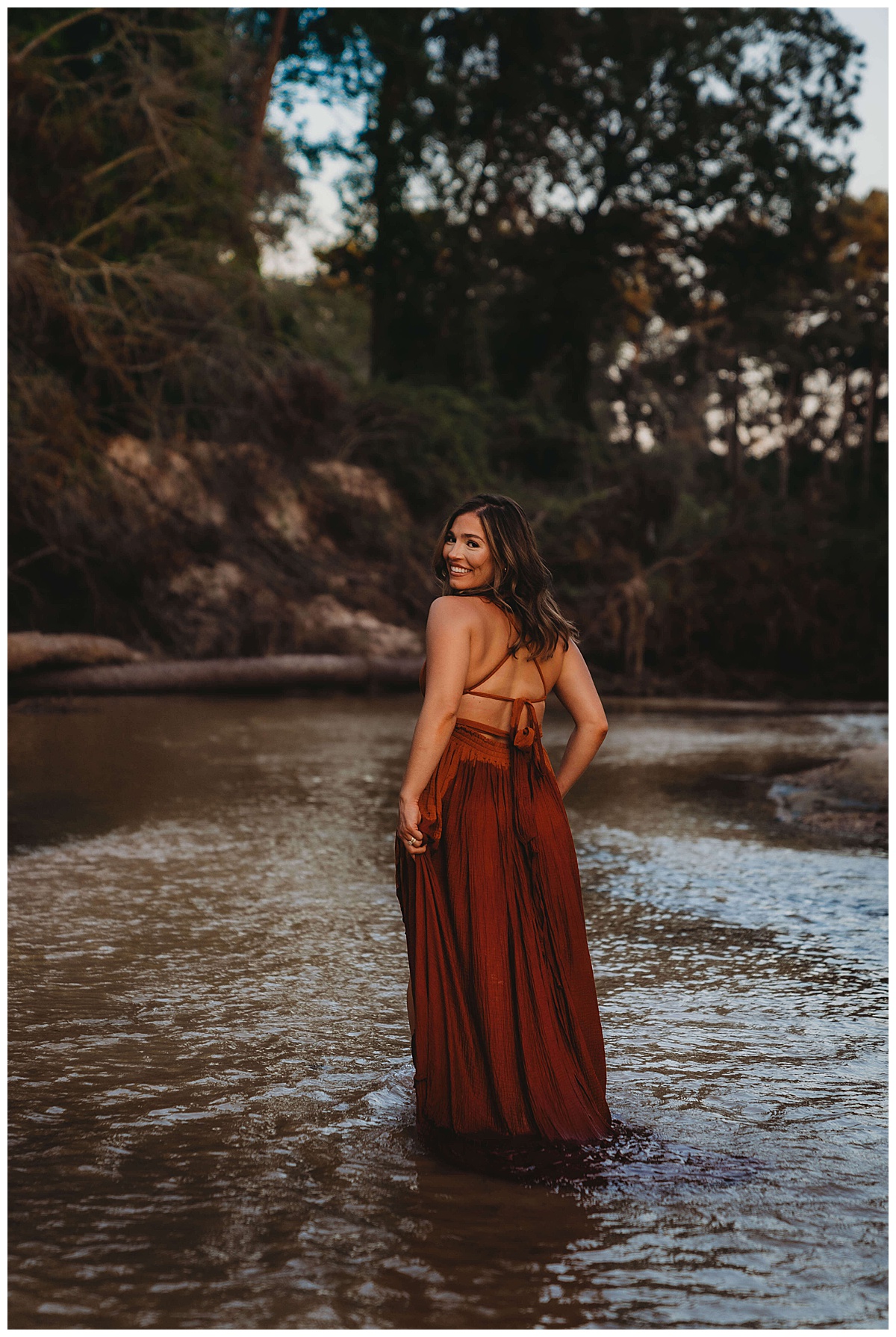 Woman smiles wearing a dress in the water for The Woodlands Family Photographer