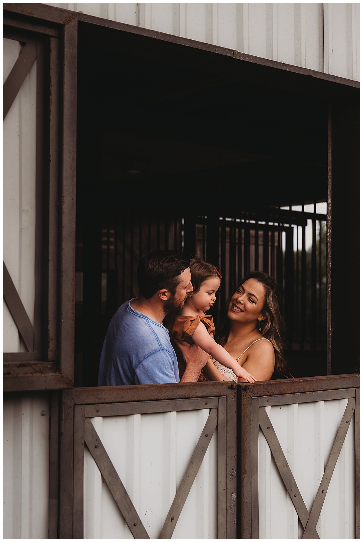 Parents stand with young child in the window for Maria Grace Photos