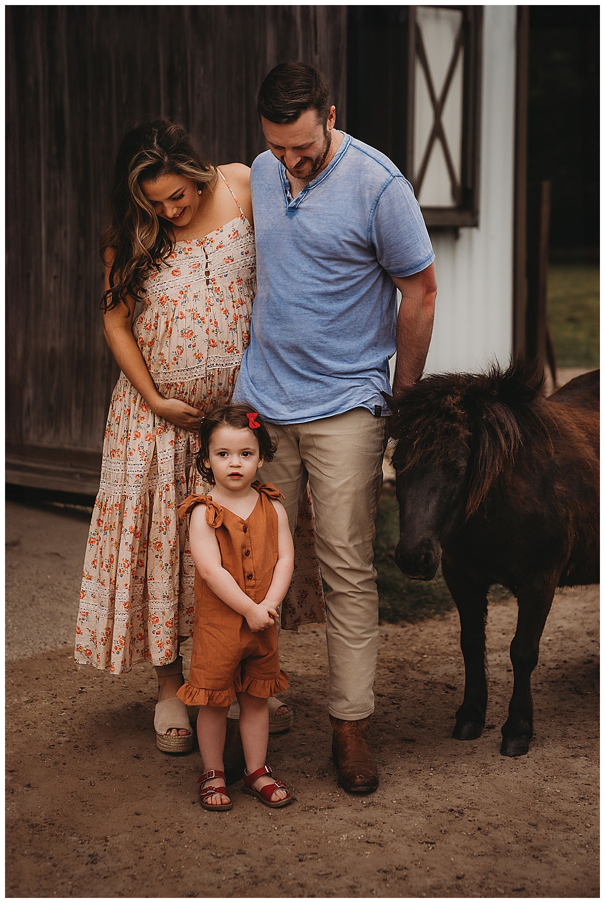 Parents stand near young horse Embracing Imperfection during family photos 