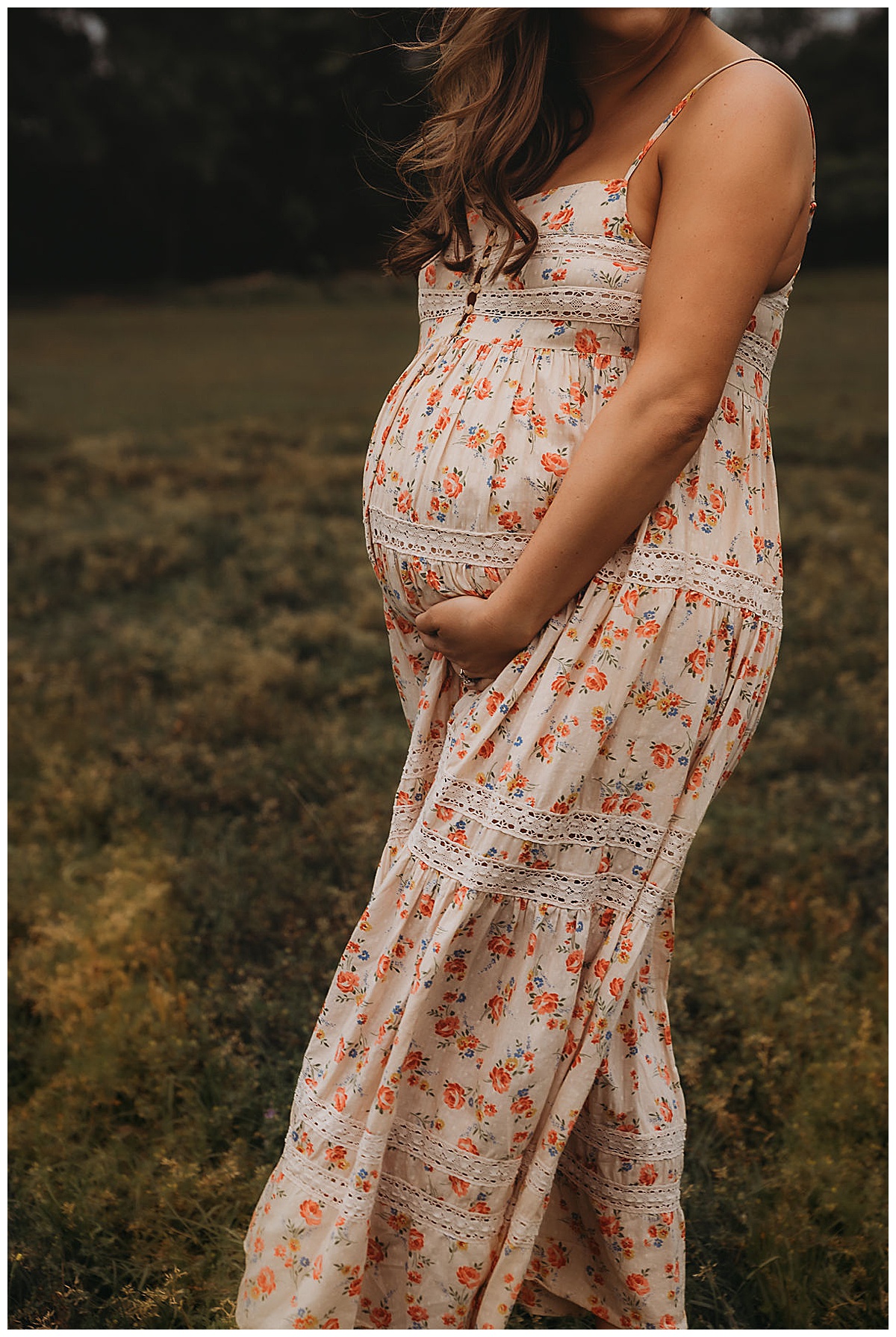 Mom holds her pregnant belly Embracing Imperfection during family photos 