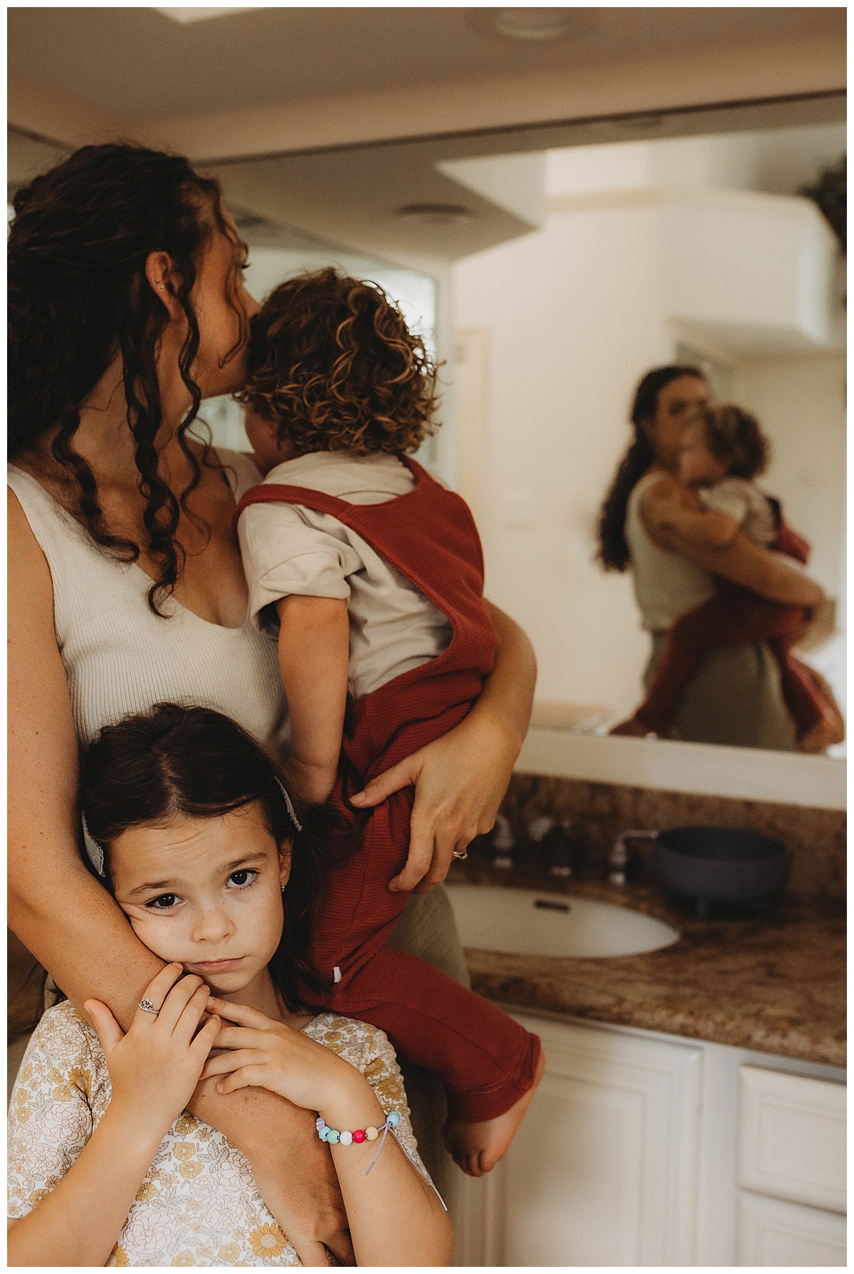 Family stand together holding each other close for The Woodlands Family Photographer