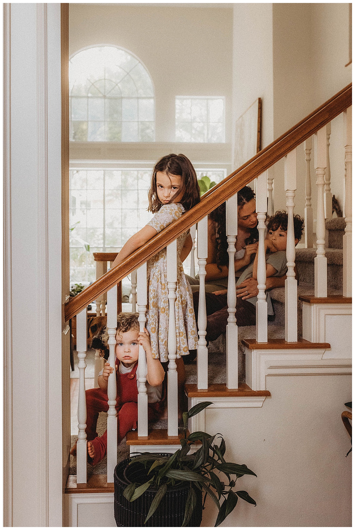 Family sit on the stairs together for The Woodlands Family Photographer