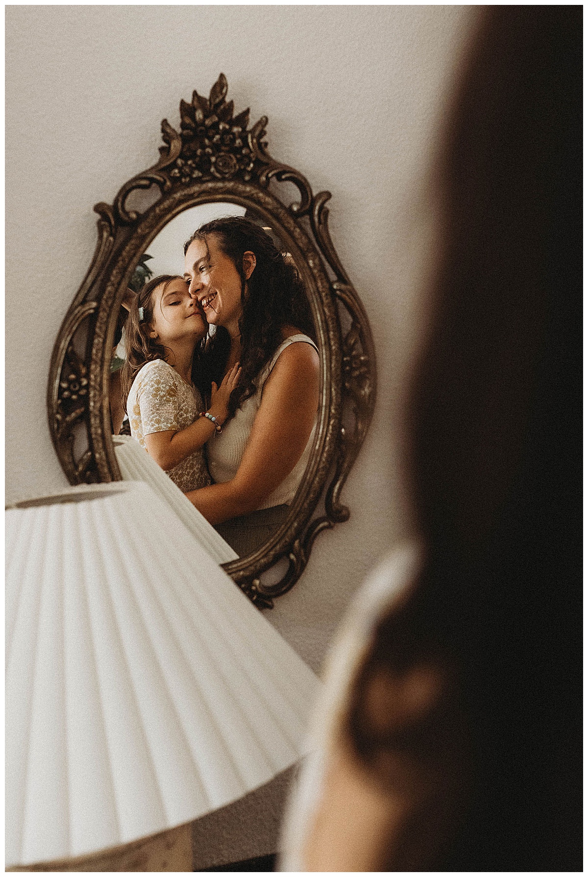 Mother holds young child close for Maria Grace Photos