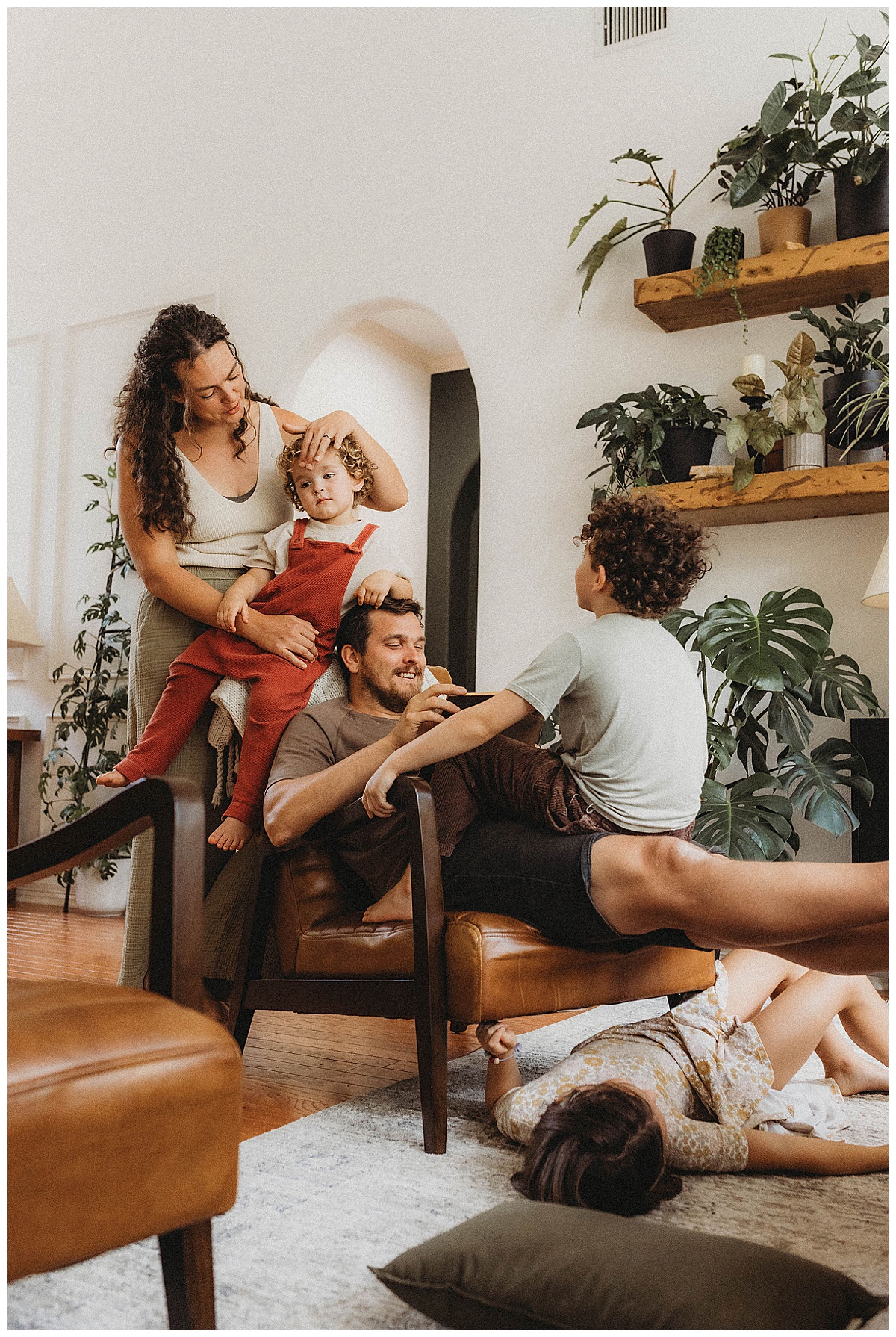 Parents sit near their kids for The Woodlands Family Photographer