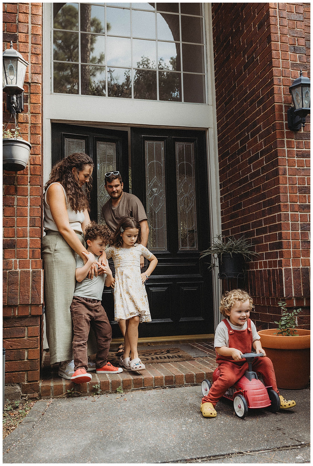 Family stand outside their home for Maria Grace Photos